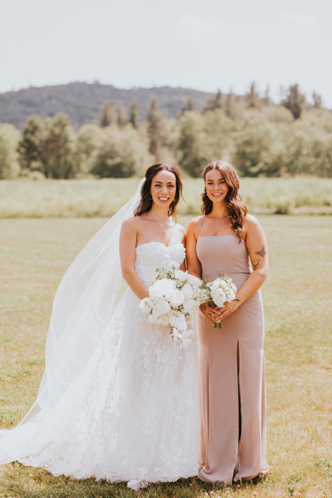 bride with big bouquet and bridesmaid with small bouquet