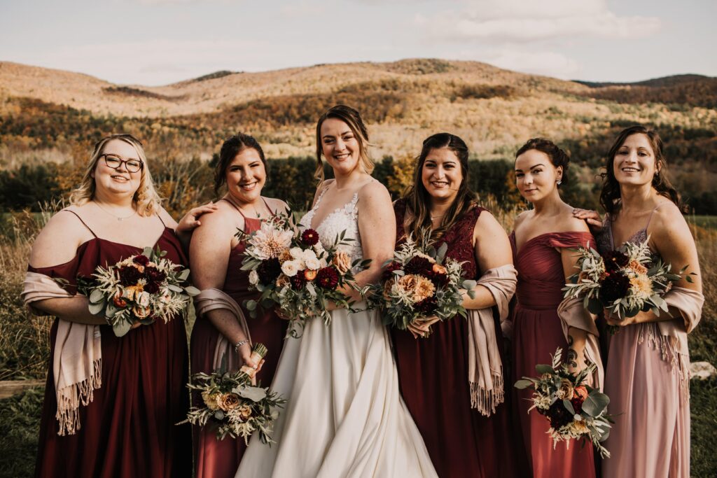 bride with her bridesmaids at a fall wedding