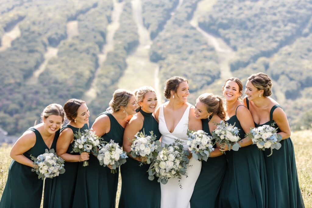 bride with her bridesmaids holding bouquets 