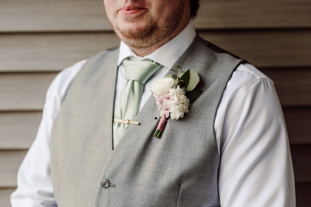 Spring Boutonniere with blush and white flowers 