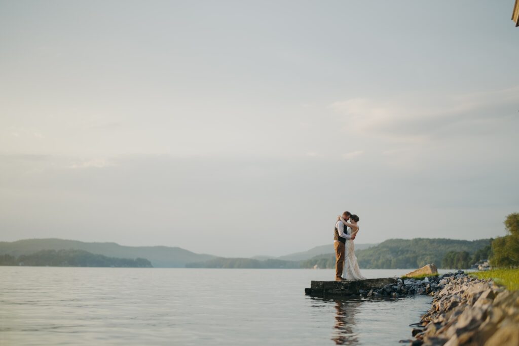 wide angle photo of couple at the at the lake bomoseen lodge dock 