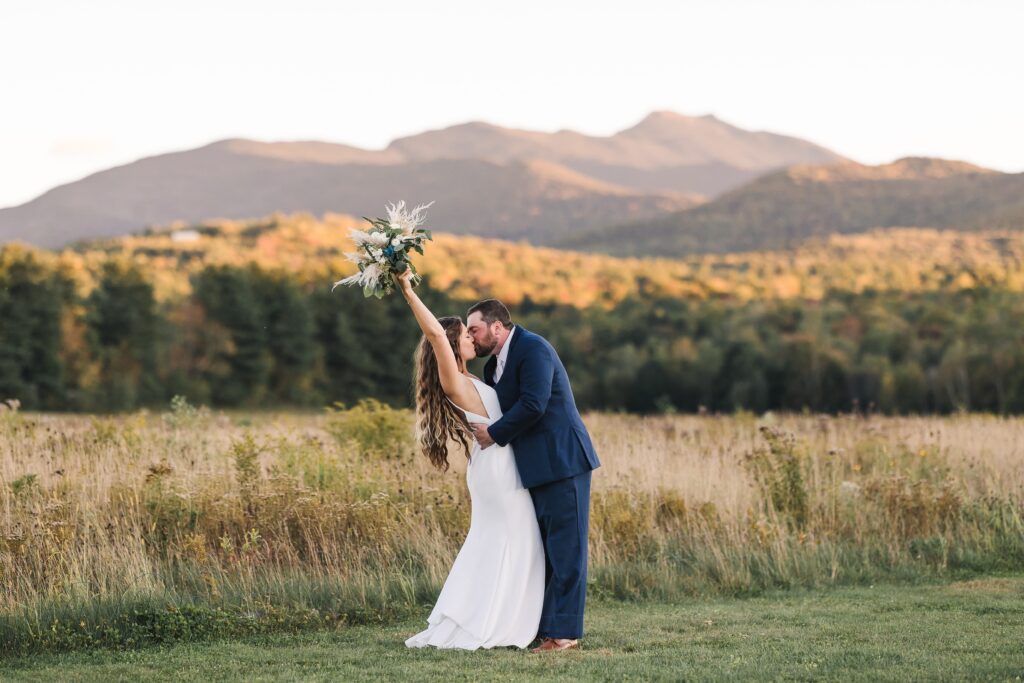 wedding couple with mountain view at the barn at smugglers notch, vermont wedding venues 