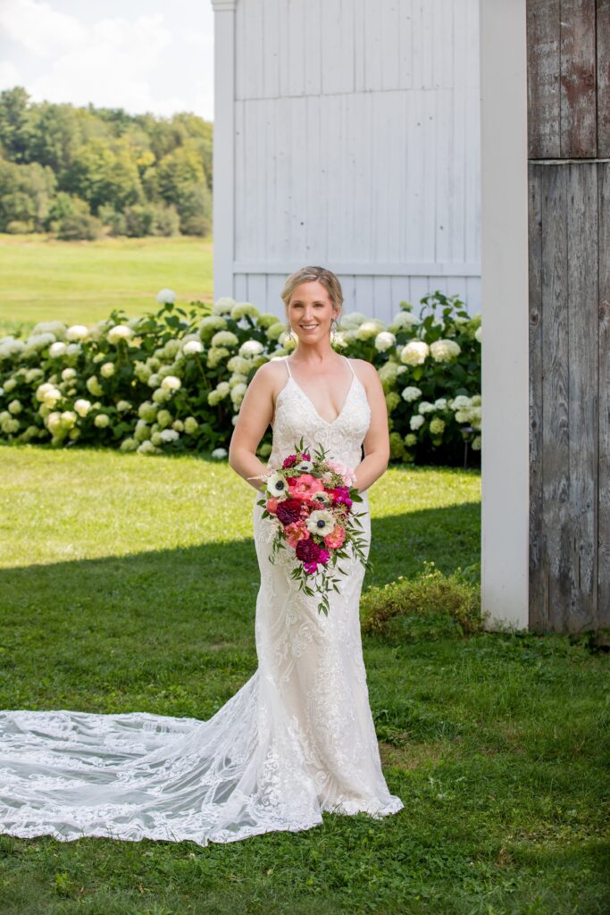 bride posing in front of hydrangeas at the  vermont swiss and bloom farm 