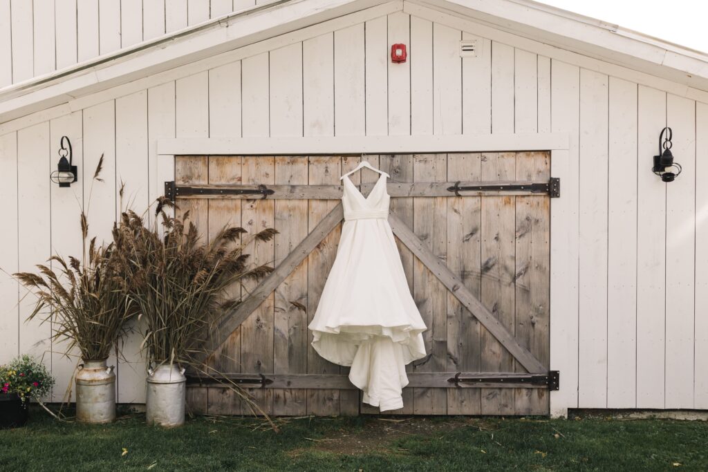 wedding dress hanging from the  vermont swiss and bloom farm 
