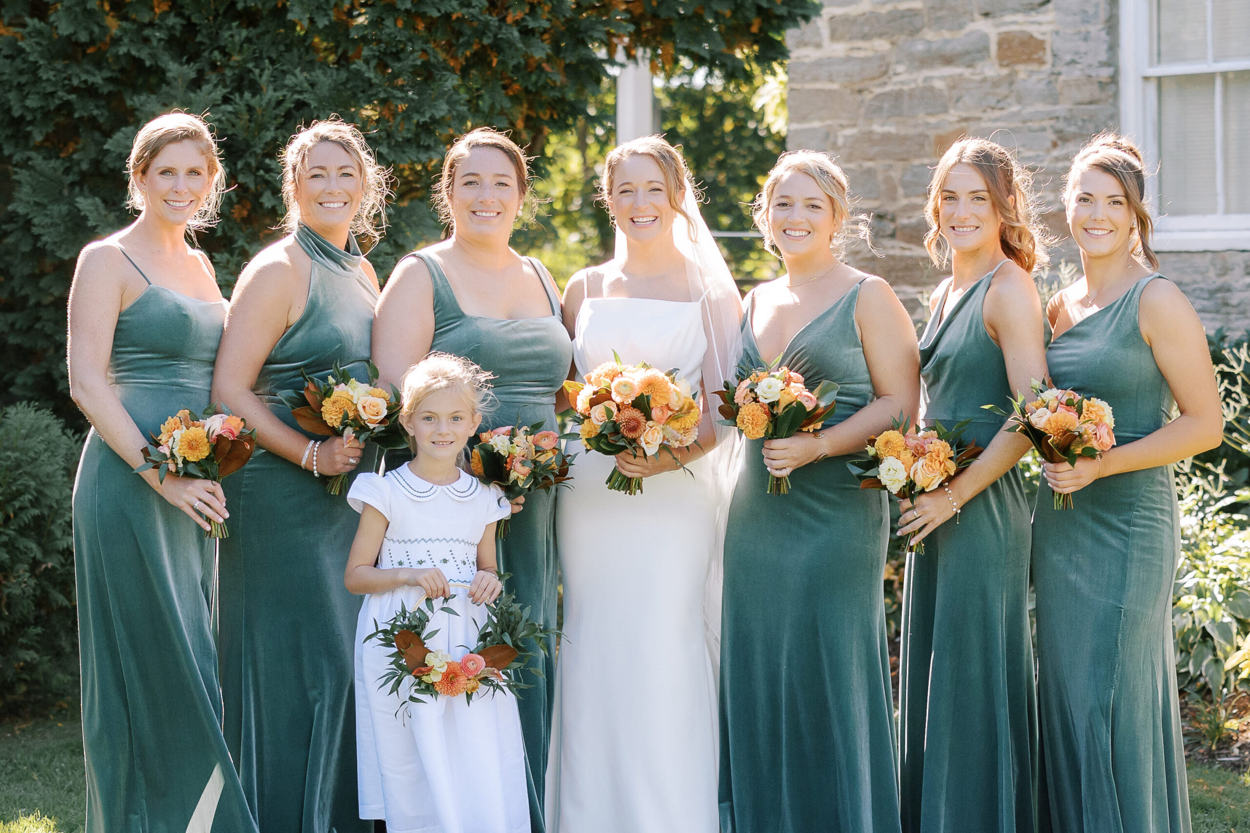 Bridal party holding their dahlia bouquets including a flower girl and her flower girl basket.