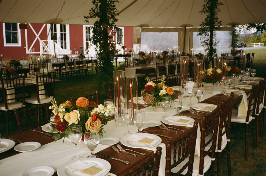 A beautiful and moody tablescape inside the outdoor tented reception area at Hill Farm Inn. 